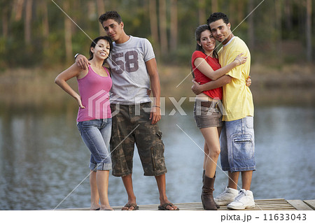 Two young couples standing on dock 11633043