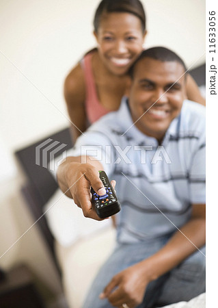 African couple watching television 11633056