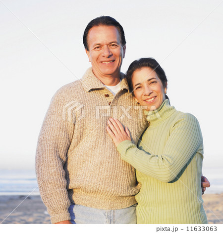 Hispanic couple hugging at beach Hispanic couple hugging at beach 11633063
