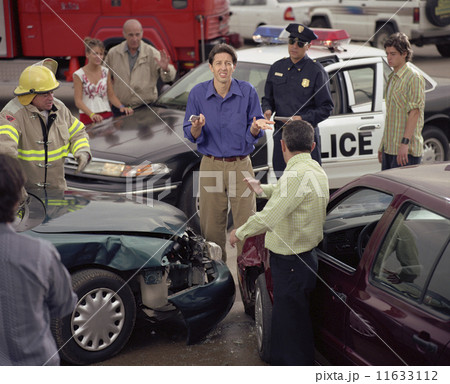 Hispanic man shrugging shoulders in middle of accident scene 11633112