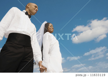 African bride and groom holding hands 11633119