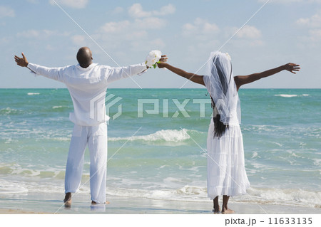 African bride and groom with arms outstretched 11633135
