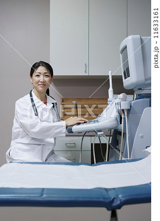 Portrait of technician using equipment in examination room 11633161