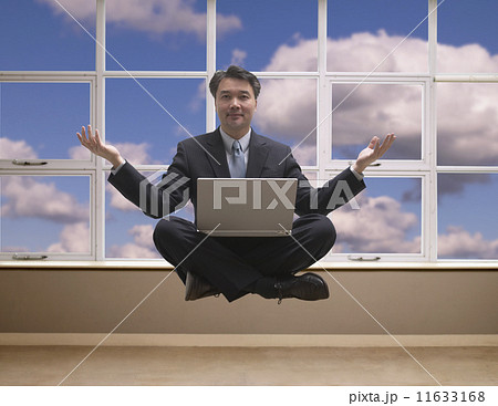 Asian businessman levitating cross-legged with laptop 11633168