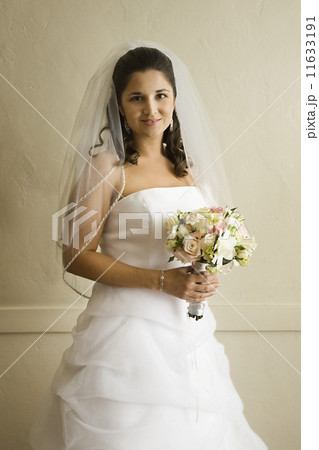 Hispanic bride holding bouquet Hispanic bride holding bouquet 11633191