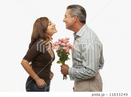 Hispanic man giving flowers to wife 11633249