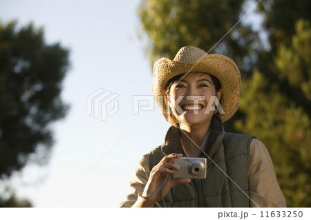 Asian woman holding camera 11633250