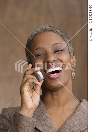 Mid adult business woman talking on cell phone 11633346