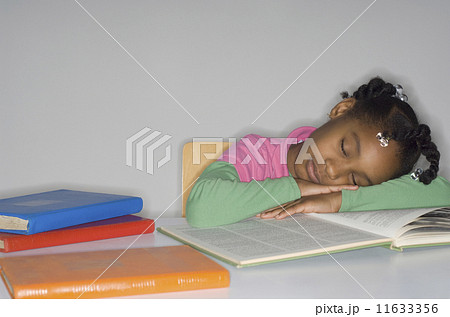 African girl sleeping on open book 11633356