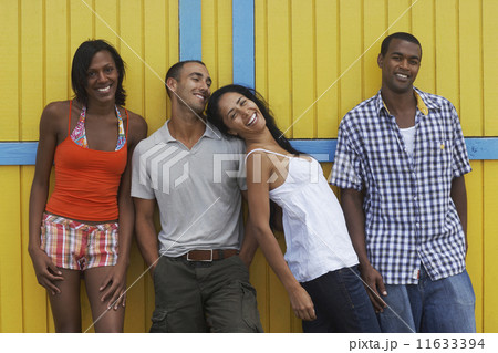 Multi-ethnic friends leaning on wall Multi-ethnic friends leaning on wall 11633394
