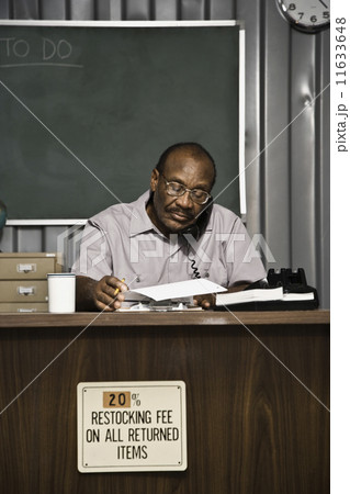 Senior African American male worker talking on telephone 11633648