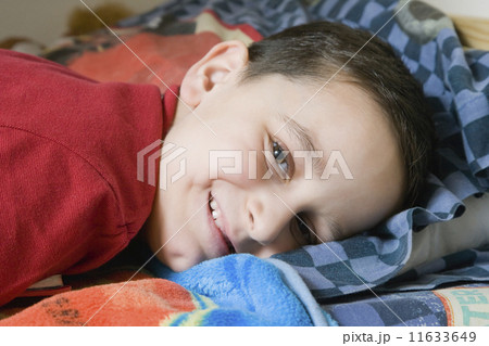 Hispanic boy laying in bed 11633649