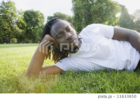 Portrait of African man laying in grass  11633650
