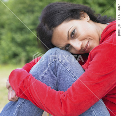 Portrait of Indian woman with head on knees 11633667