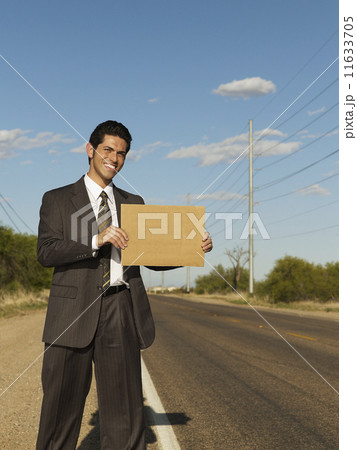 Hispanic businessman holding blank sign 11633705