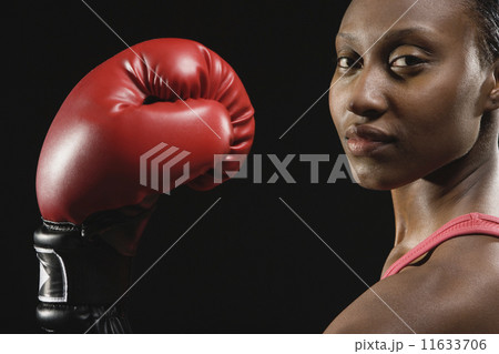 African American woman wearing boxing glove 11633706