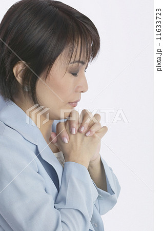 Asian businesswoman praying Asian businesswoman praying 11633723