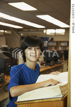 Asian boy using library dictionary Asian boy using library dictionary 11633732