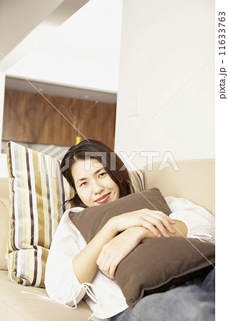 Asian woman hugging pillow Asian woman hugging pillow 11633763