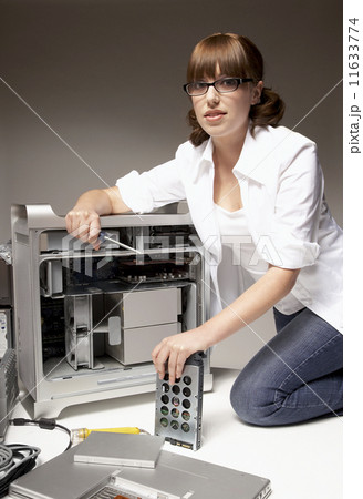 Hispanic woman installing computer hardware Hispanic woman installing computer hardware 11633774