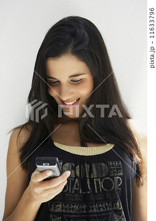 South American woman looking at cell phone South American woman looking at cell phone 11633796