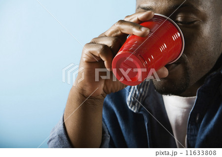 African man drinking from plastic cup African man drinking from plastic cup 11633808