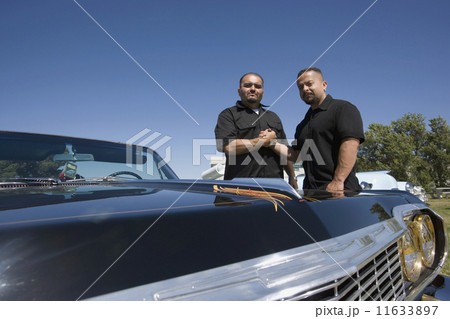 Hispanic men next to show car 11633897