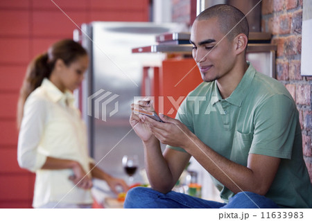 African American man holding electronic organizer 11633983
