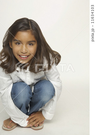Close up of Hispanic girl crouching 11634103