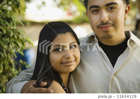 Teenaged Hispanic couple hugging 11634129