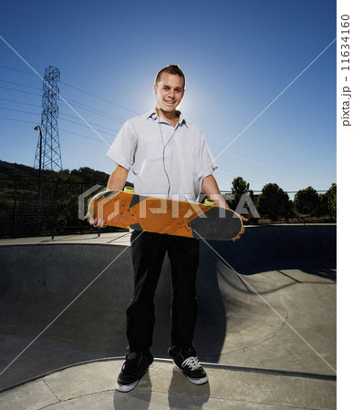 Portuguese young man holding skateboard Portuguese young man holding skateboard 11634160