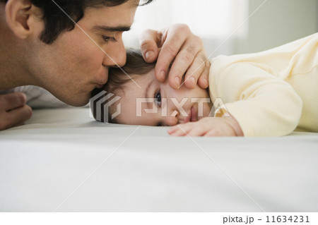 Hispanic father kissing baby 11634231