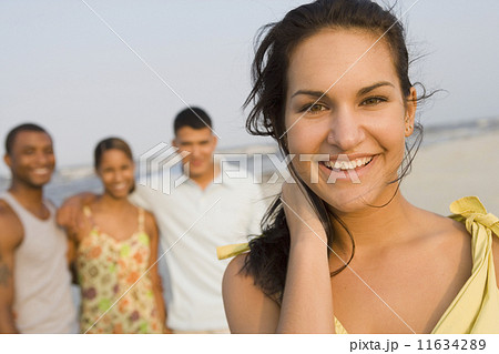 Hispanic woman with friends in background Hispanic woman with friends in background 11634289