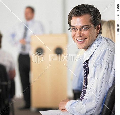 Businessman smiling in conference Businessman smiling in conference 11634306
