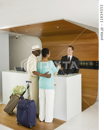 Senior African couple at hotel counter Senior African couple at hotel counter 11634355