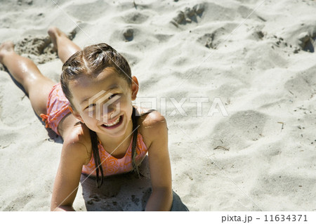 Asian girl laying in sand Asian girl laying in sand 11634371