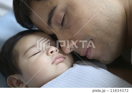 Close up of father sleeping with baby 11634372