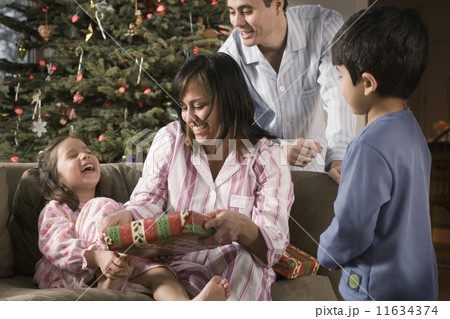 Hispanic family opening gifts on Christmas Hispanic family opening gifts on Christmas 11634374