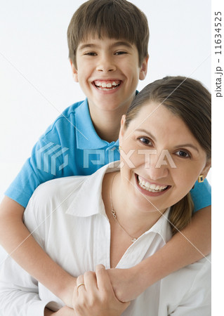 Mother carrying her son on her back 11634525