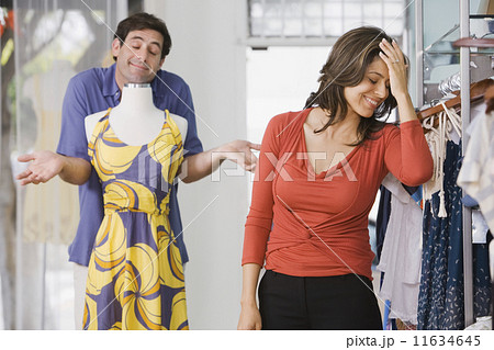 Hispanic couple shopping in clothing store 11634645