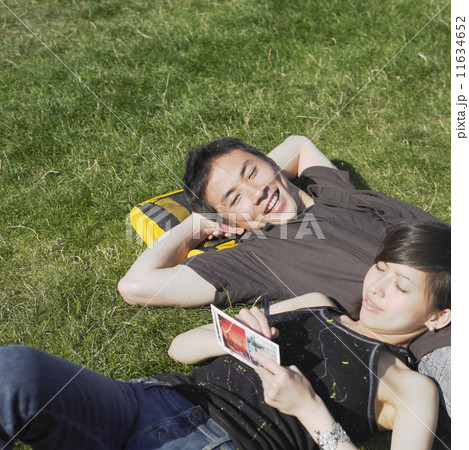Young couple relaxing in grass Young couple relaxing in grass 11634652