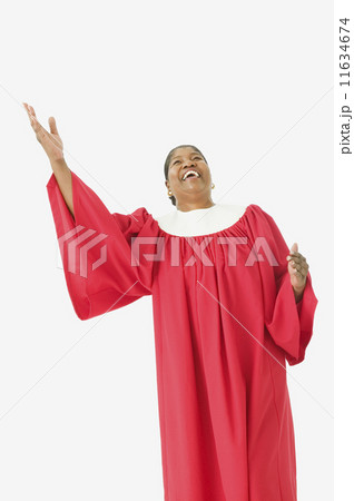 Studio shot of senior African woman wearing a choir robe and singing Studio shot of senior African woman wearing a choir robe and singing 11634674