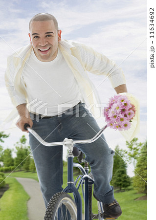 African American man riding bicycle African American man riding bicycle 11634692