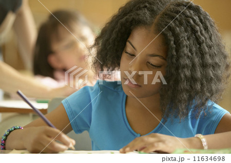 Young girl working in classroom Young girl working in classroom 11634698