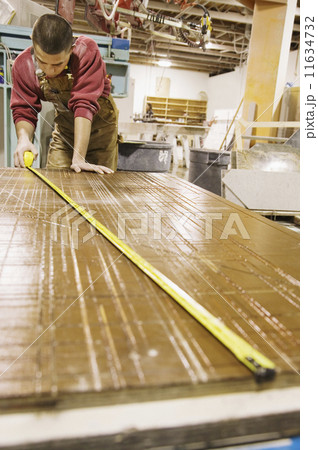 Man measuring in workshop 11634732