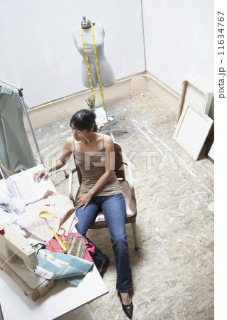 Young seamstress using a laptop 11634767