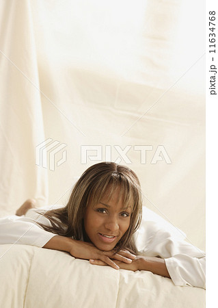 Portrait of African woman laying on bed 11634768