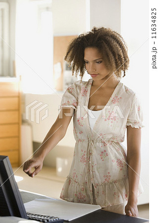 African businesswoman pointing at computer African businesswoman pointing at computer 11634825