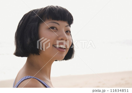 Close up of Asian woman at beach 11634851