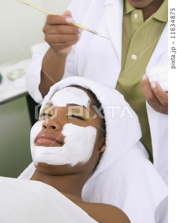 African woman receiving spa facial treatment African woman receiving spa facial treatment 11634875